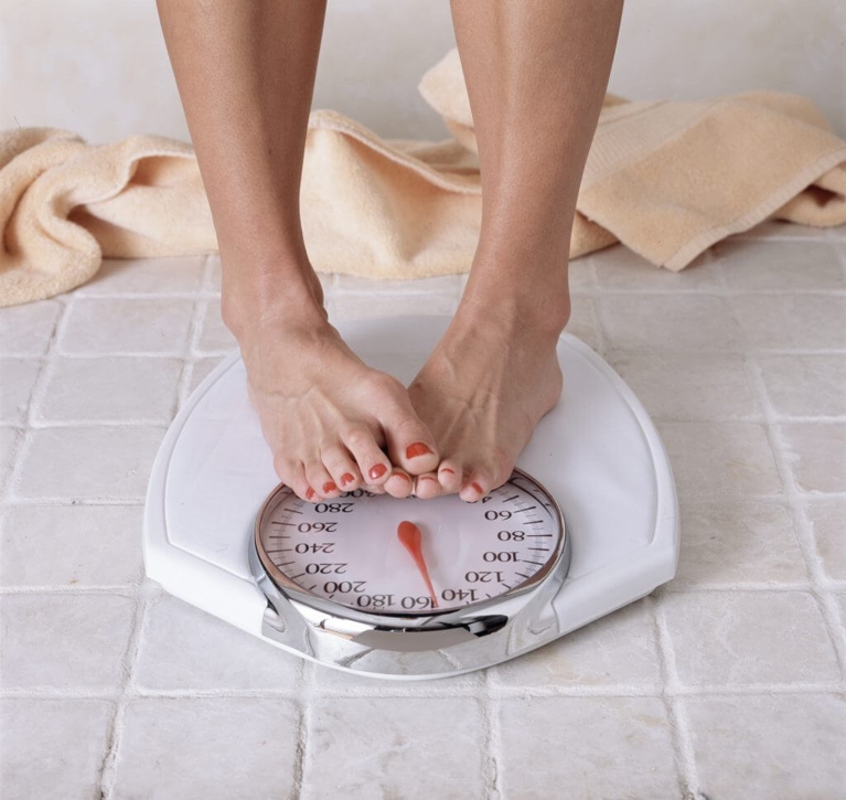 Person's Feet Standing on a Weighing Scale