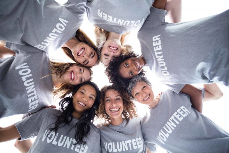 Female Volunteers Banning Together, Smiling