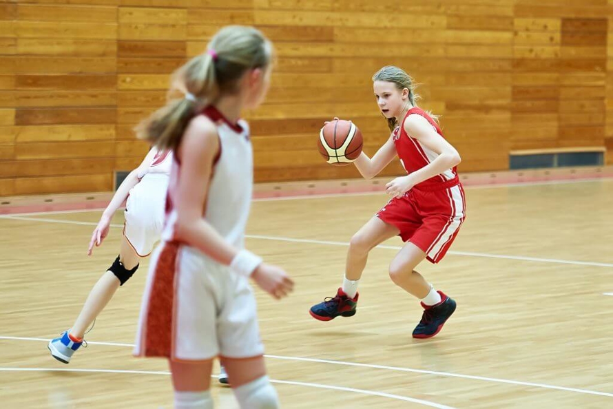 Little Girl in a Red Jersey Playing Basketball