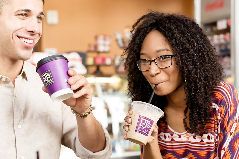 young couple drinking PJ's Coffee beverages