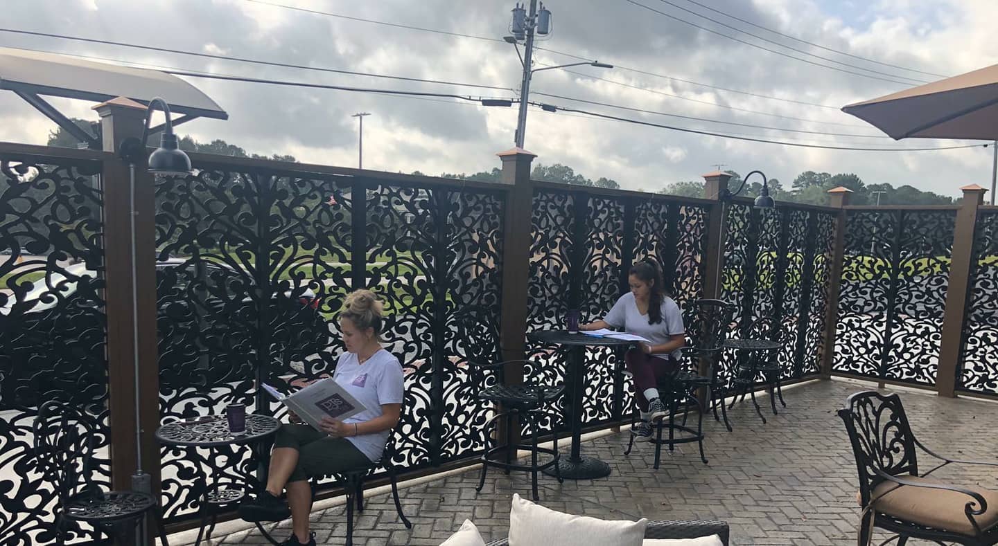 Women reading the newspaper at PJs Coffee