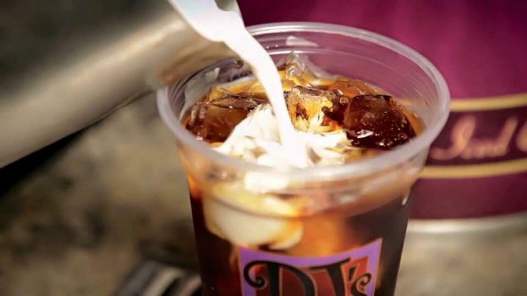 Creamer Being Poured into a Cup of Iced Coffee