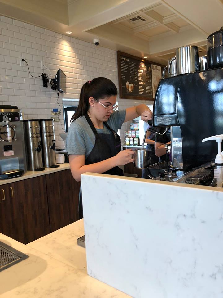 PJ's Coffee barista using equipment