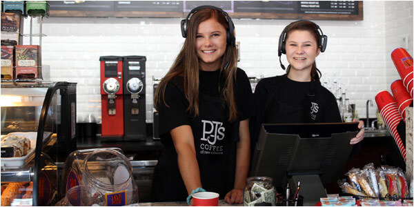 Young Female PJ's Coffee Serving Coffee with a Smile